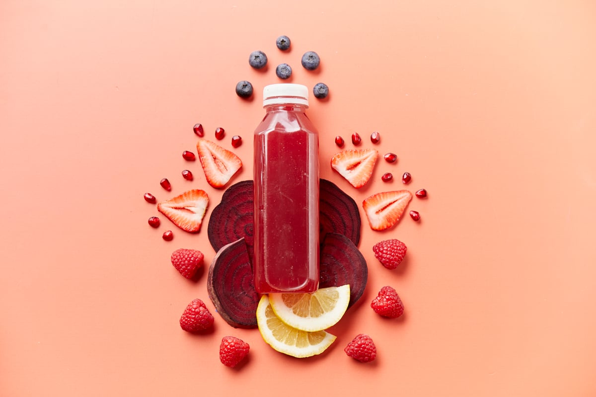 Red juice flatly with sliced strawberries, blueberries, lemons and raspberries