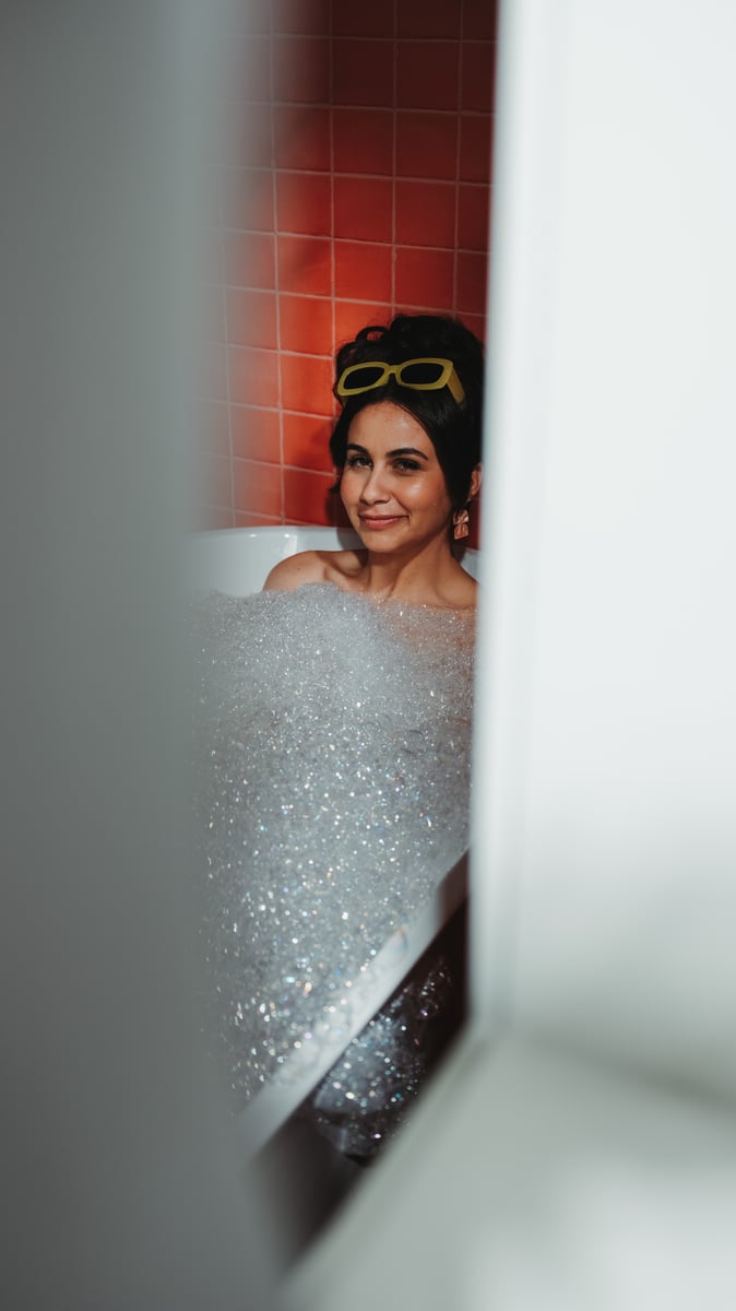 Katherine in bathtub filled with bubbles