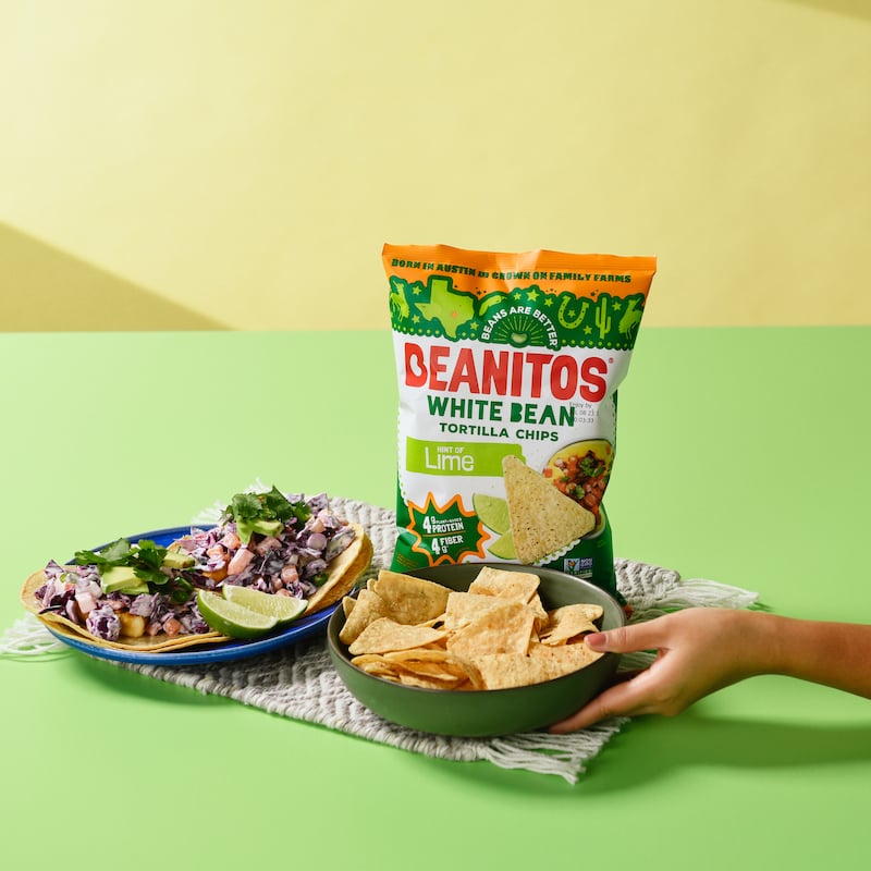 Hand reaching in for a bowl of Beanitos tortilla chips