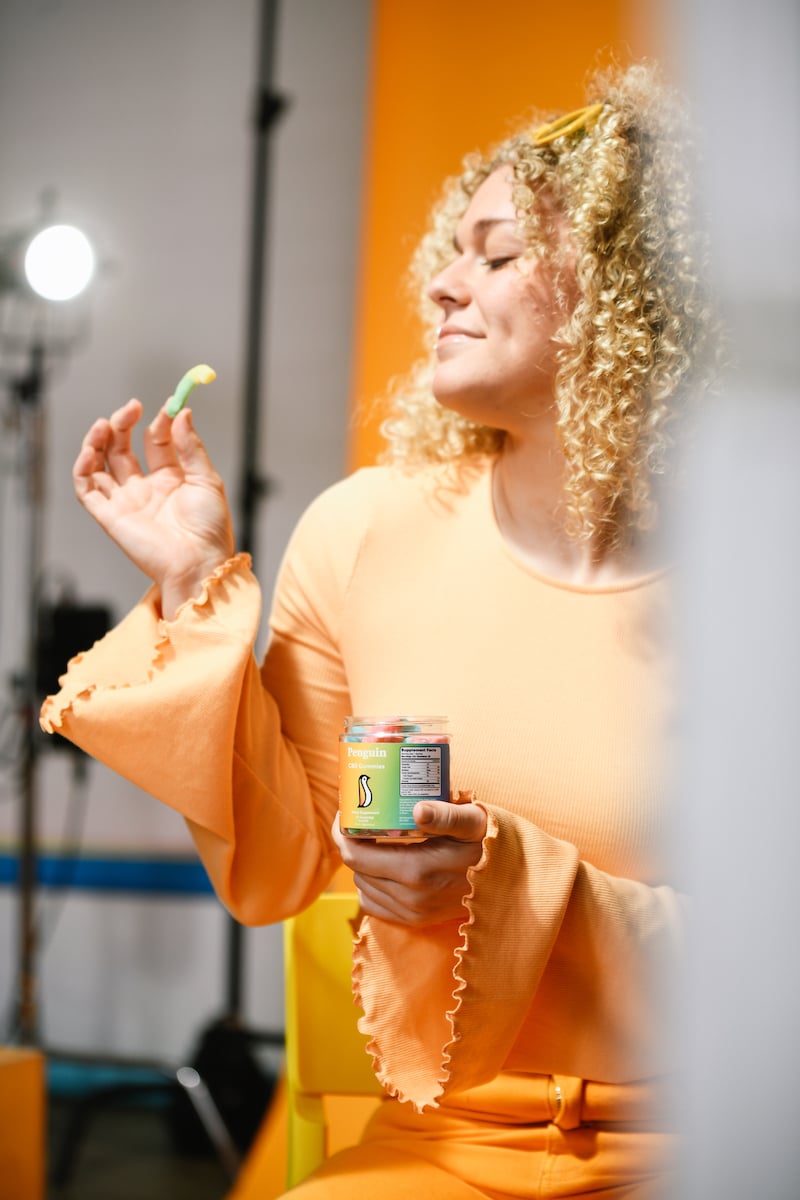 Model about to eat a CBD gummy worm